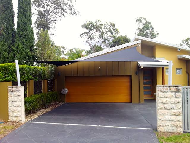 Shade Sail used to cover driveway in front of garage