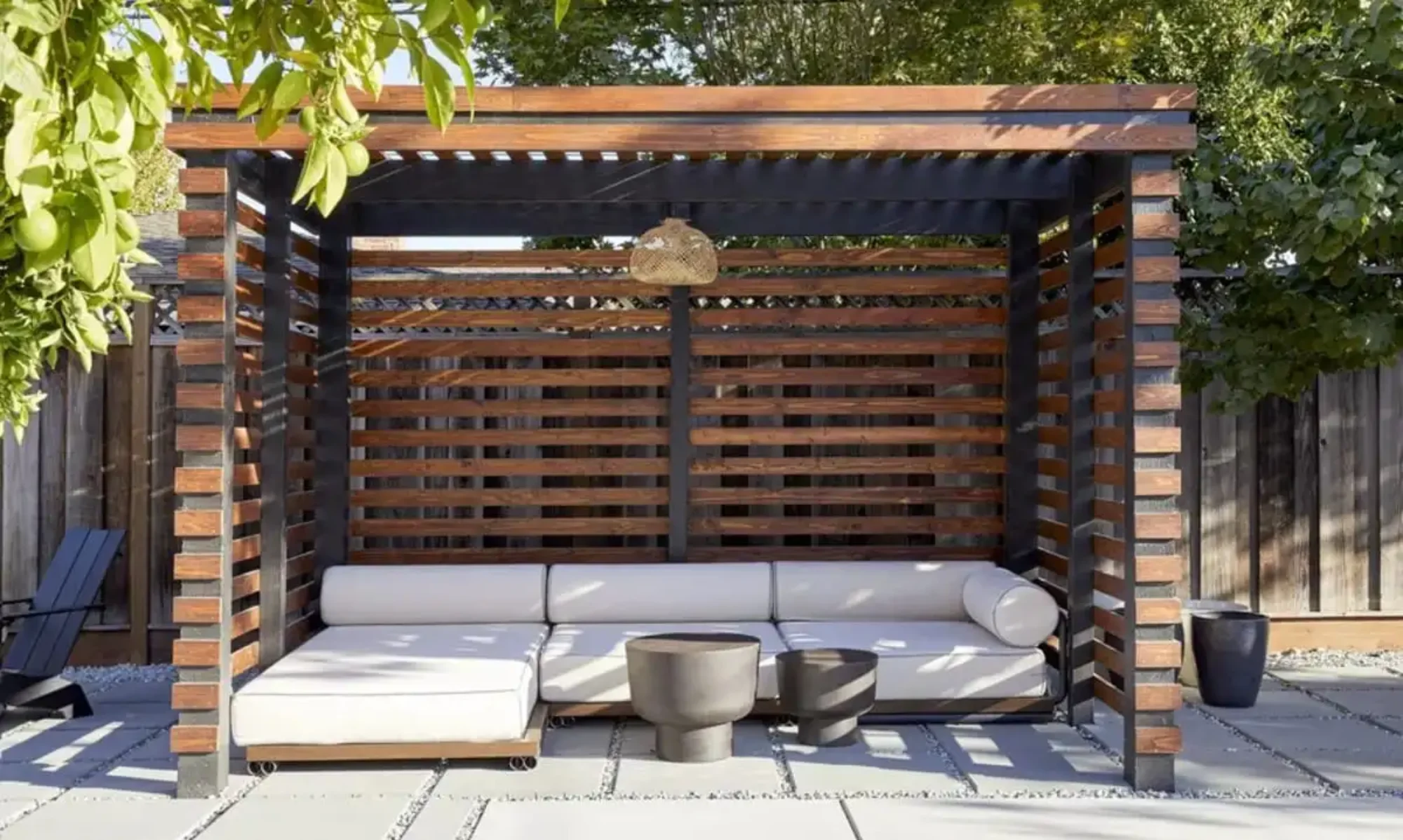 modern black and brown pergola creating an intimate sitting area outdoors