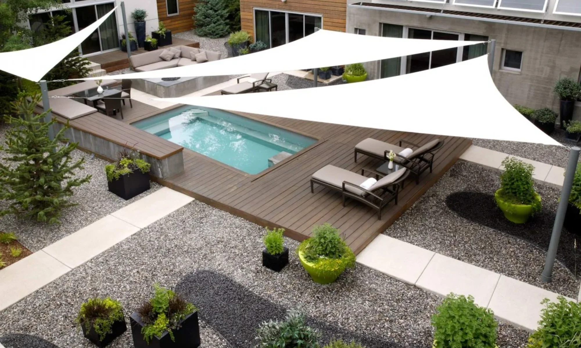 Three triangular shade sails providing shade to the back deck and jacuzzi