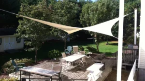 Square shade sail in hypar providing shade over a patio